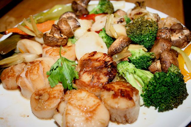 Steamed scallops with lemon, ginger, and sake; sauteed summer vegetables